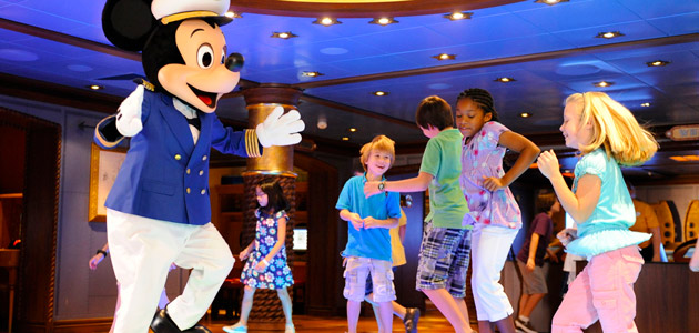 Captain Mickey dancing with young guests in Disney's Oceaneer Club.
