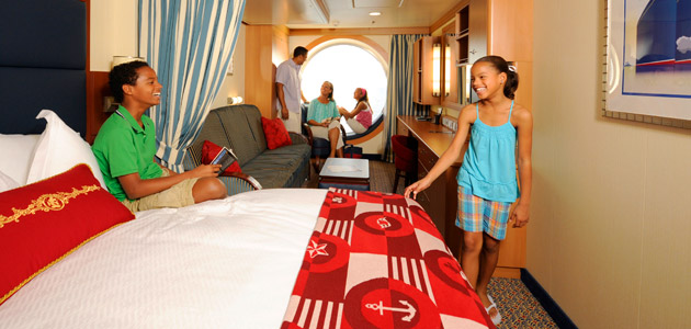 Family in a beautiful Oceanview Stateroom onboard Disney Dream.