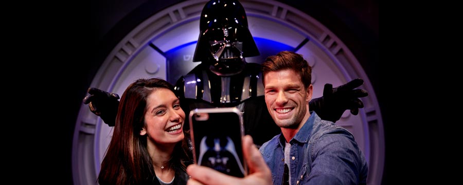 Couple taking selfie with darth vader.
