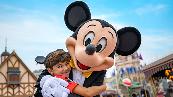 Boy hugging Mickey in Magic Kingdom
