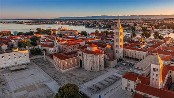 Zadar’s Roman Forum with Saint Donatus Church and Saint Anastasia Cathedral bell tower at sunset 