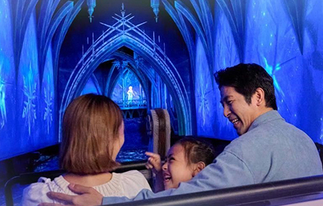 Young family aboard a boat on Frozen Ever After in World of Frozen