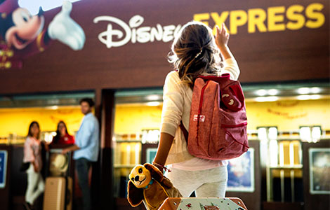 Guest dropping off luggage at Disney Express Luggage Service Counter