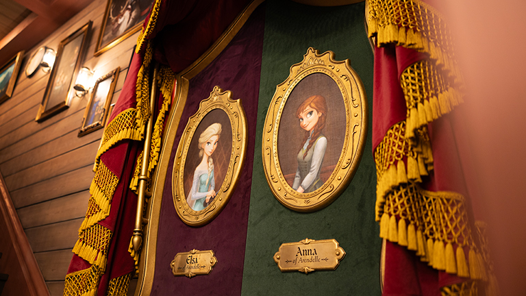 World of Frozen's The Nordic Crowns Tavern with framed portraits of Elsa and Anna