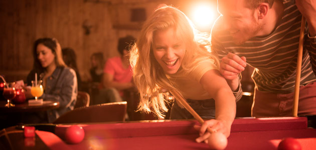 Couple enjoying a game of pool.