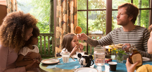 Family eating breakfast in their cabin at Disney Davy Crockett Ranch