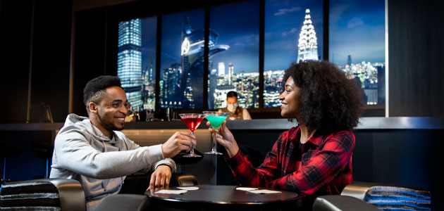 Couple enjoying cocktails at Skyline Bar
