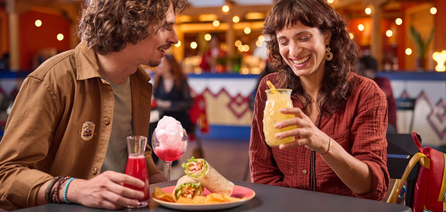 Couple eating and drinking at Rio Grande Bar at Disney Hotel Santa Fe.