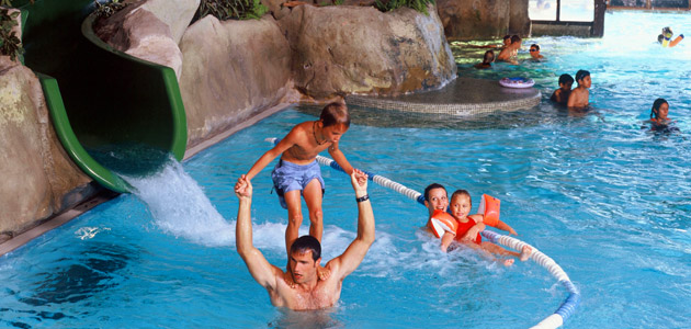 Water games, waterfall and slide in the swimming pool