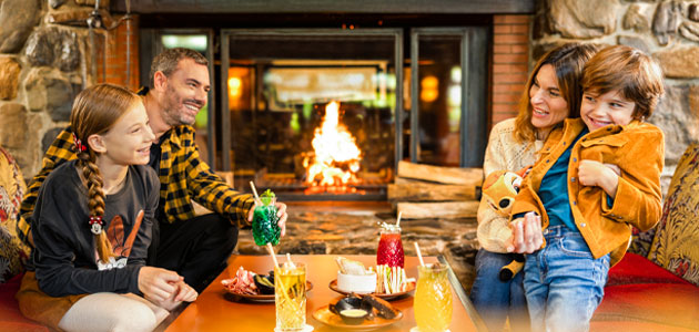 Family by the fire at Disney Sequoia Lodge
