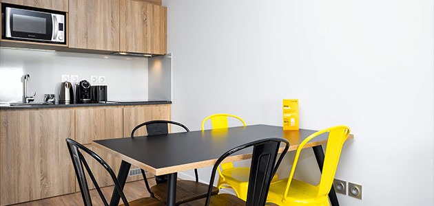 Kitchen and dining room in a Staycity Aparthotels Paris, Marne-La-Vallée apartment.