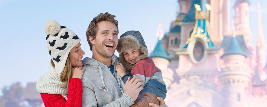 Family smiling in front of the castle