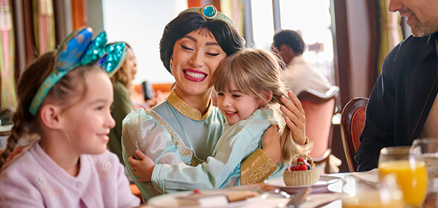 Disney Princess Jasmine hugs a young guest during a character dining experience at The Regal View Restaurant & Lounge.