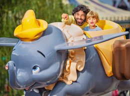 Guests on Dumbo the Flying Elephant attraction