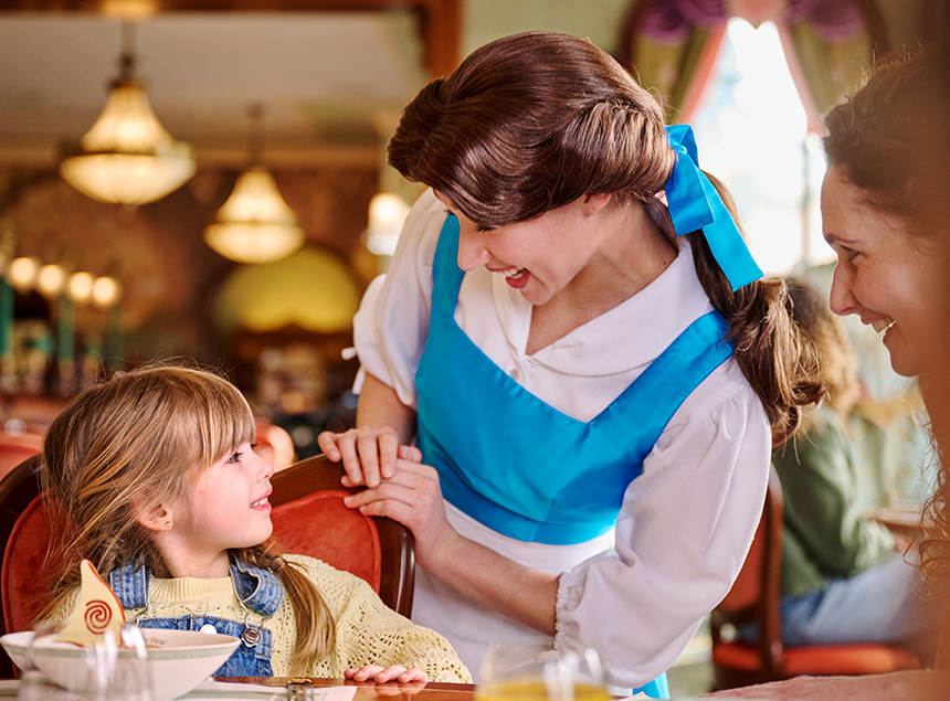 Disney Princess Belle greets a young guest during a magical character dining experience at The Regal View Restaurant & Lounge.