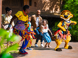 Guests dancing with The Lion King's Timon in Disneyland Park