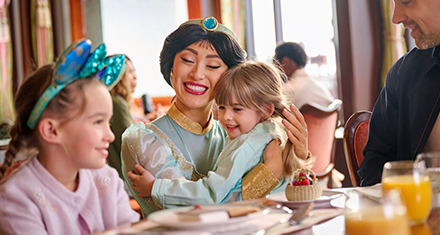 Disney Princess Jasmine hugs a young guest during a character dining experience at The Regal View Restaurant & Lounge.