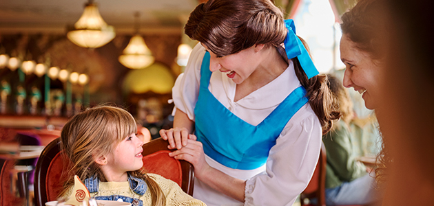 Disney Princess Belle greets a young guest during a magical character dining experience at The Regal View Restaurant & Lounge.