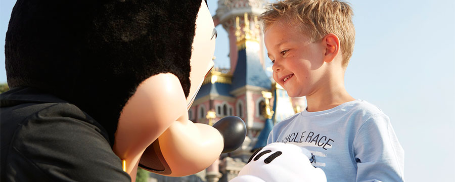 Little boy meets Mickey Mouse