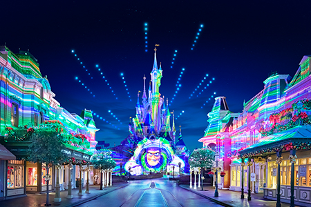 Buzz Lightyear illuminated on Sleeping Beauty Castle at Night.
