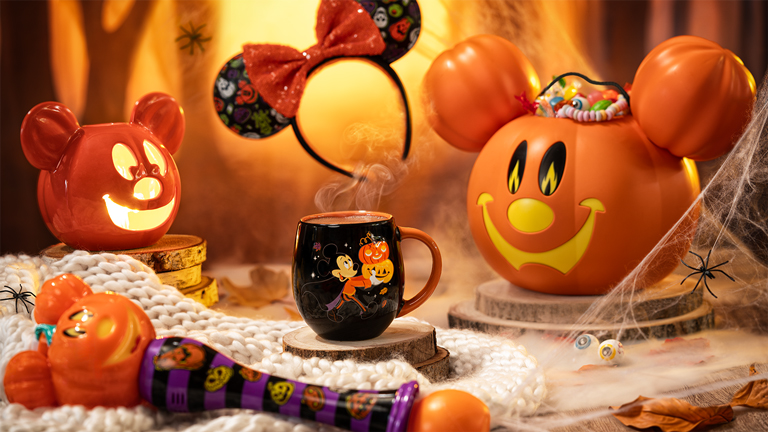 Disney Halloween Festival merchandise featuring themed accessories, a Halloween mug and pumpkin decorations on a festive Halloween-themed display