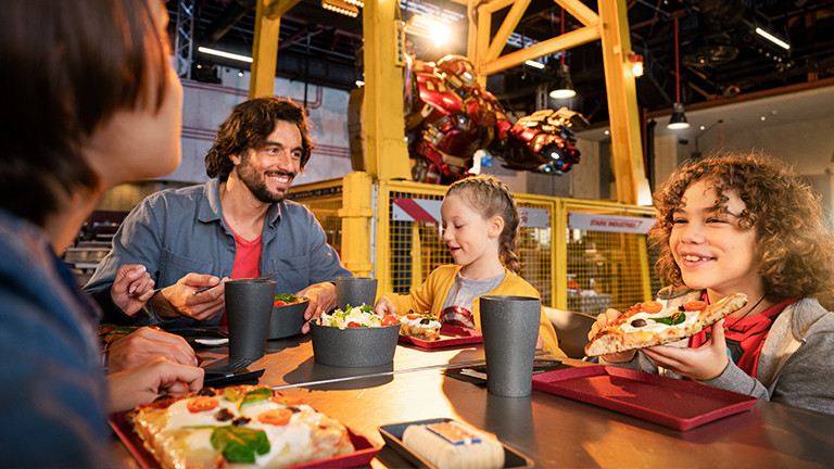 Family enjoying a quick bite at Stark Factory in Marvel Avengers Campus