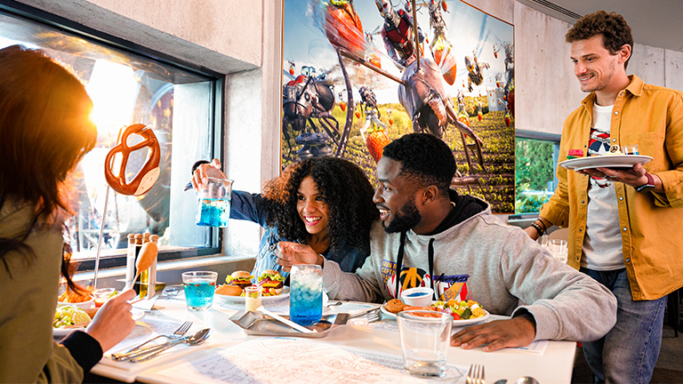 Friends admiring the range of food at PYM Kitchen in Marvel Avengers Campus