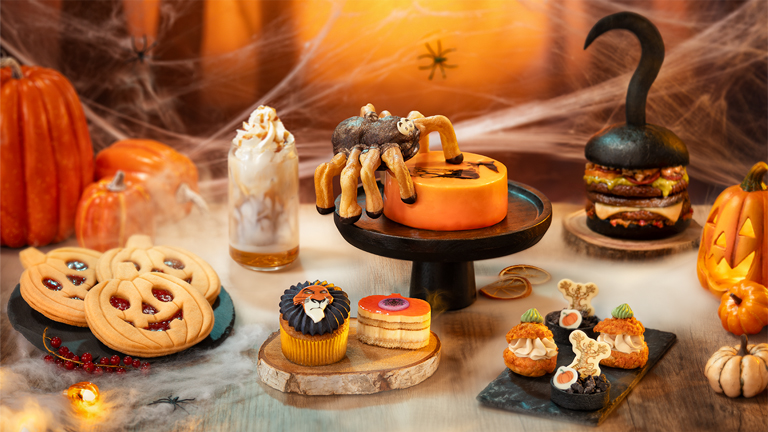 Halloween-themed food and drinks at Disney Halloween Festival, including sweet and savoury treats displayed on a decorated table