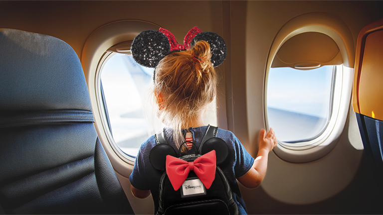Young child flying to Disneyland Paris