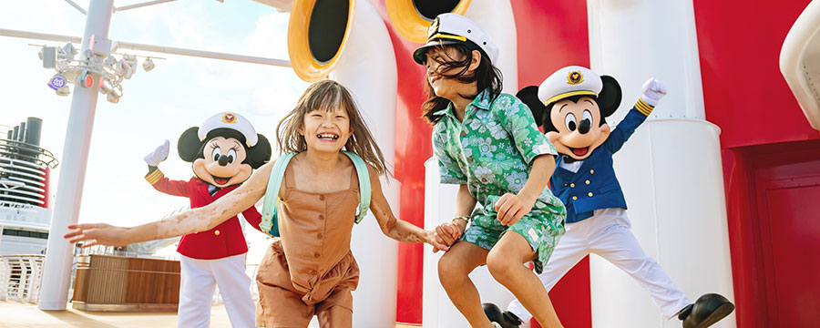 Mickey and Minnie with two kids on the cruise deck