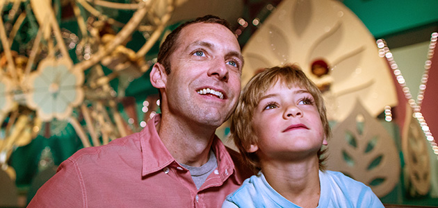 Father and son enjoying 'it's a small world' at Magic Kingdom Park.