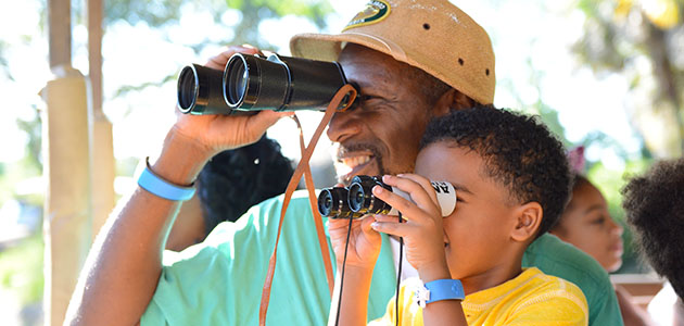 Father and son looking for animals at Kilimanjaro Safari at Disney's Animal Kingdom Theme Park.