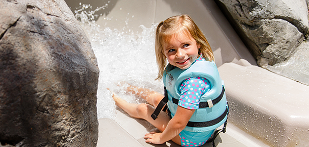 Little girl enjoying Bay Slides at Disney's Typhoon Lagoon.