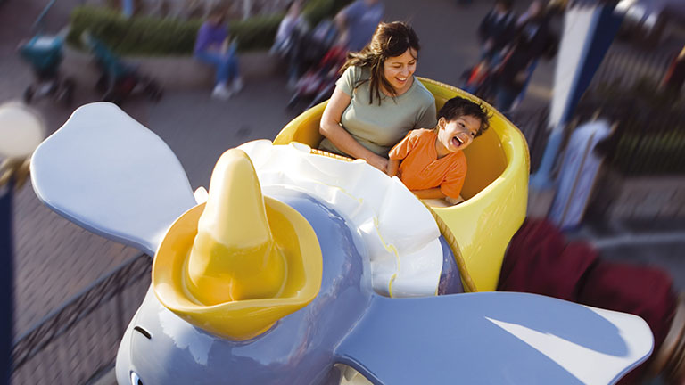 Mother and son having fun on Dumbo the Flying Elephant in Fantasyland