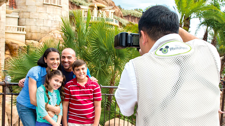 Family taking advantage of Memory Maker, having their photo taken by a Disney PhotoPass Photographer