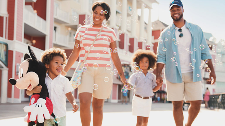 Family strolling down Disney's Boardwalk