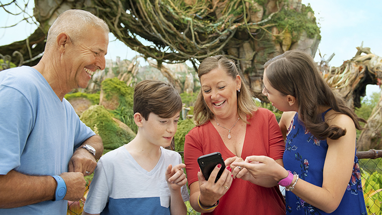 Family using the My Disney Experience app at Disney's Animal Kingdom Theme Park