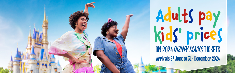 Two young girls dancing in front of Cinderella Castle